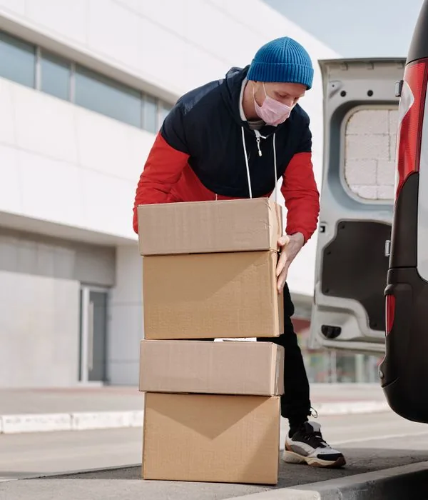 Courier moving parcels on a hand truck