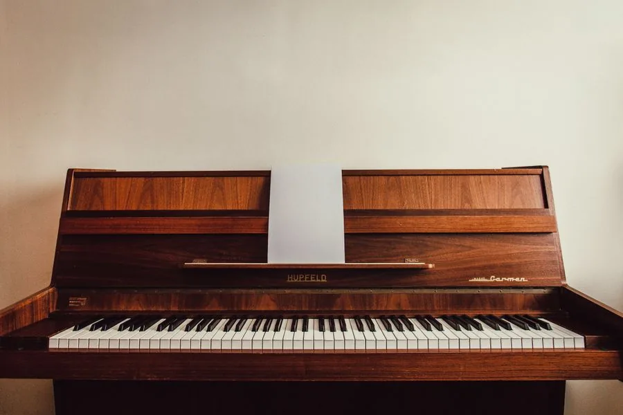 An upright piano in a home, ready to be moved with care