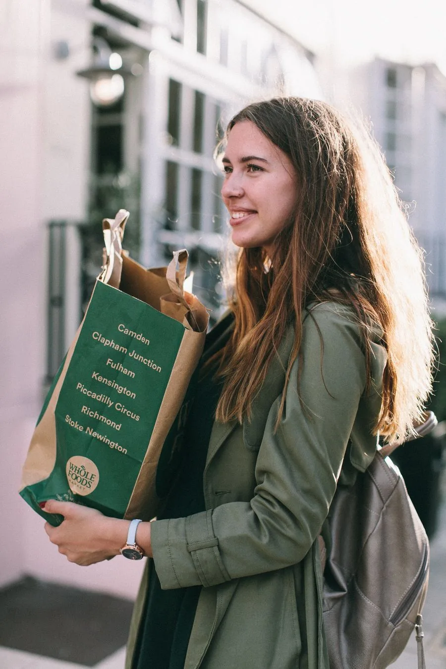 Someone carrying a paper grocery bag home