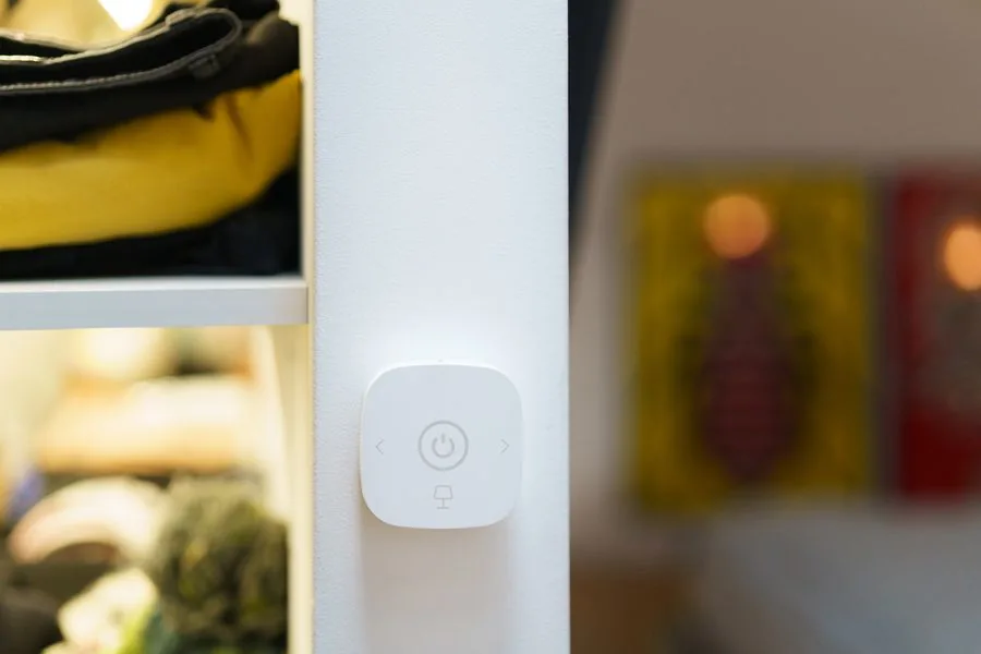 A wall-mounted smart home control switch in a modern home
