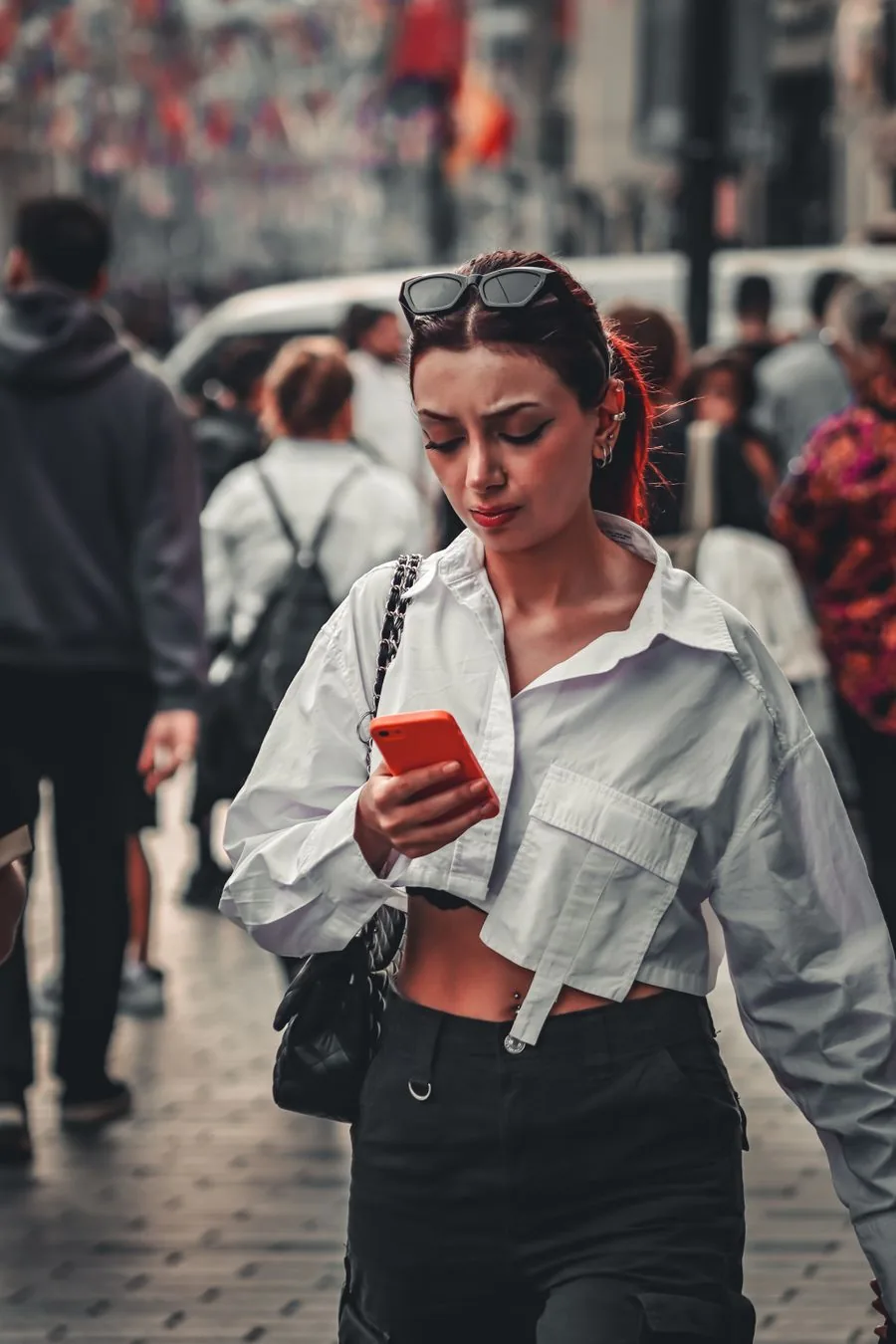 A person booking a ride on their phone in the city
