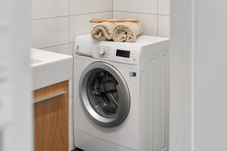 A white washing machine, the kind of old appliance hauled away