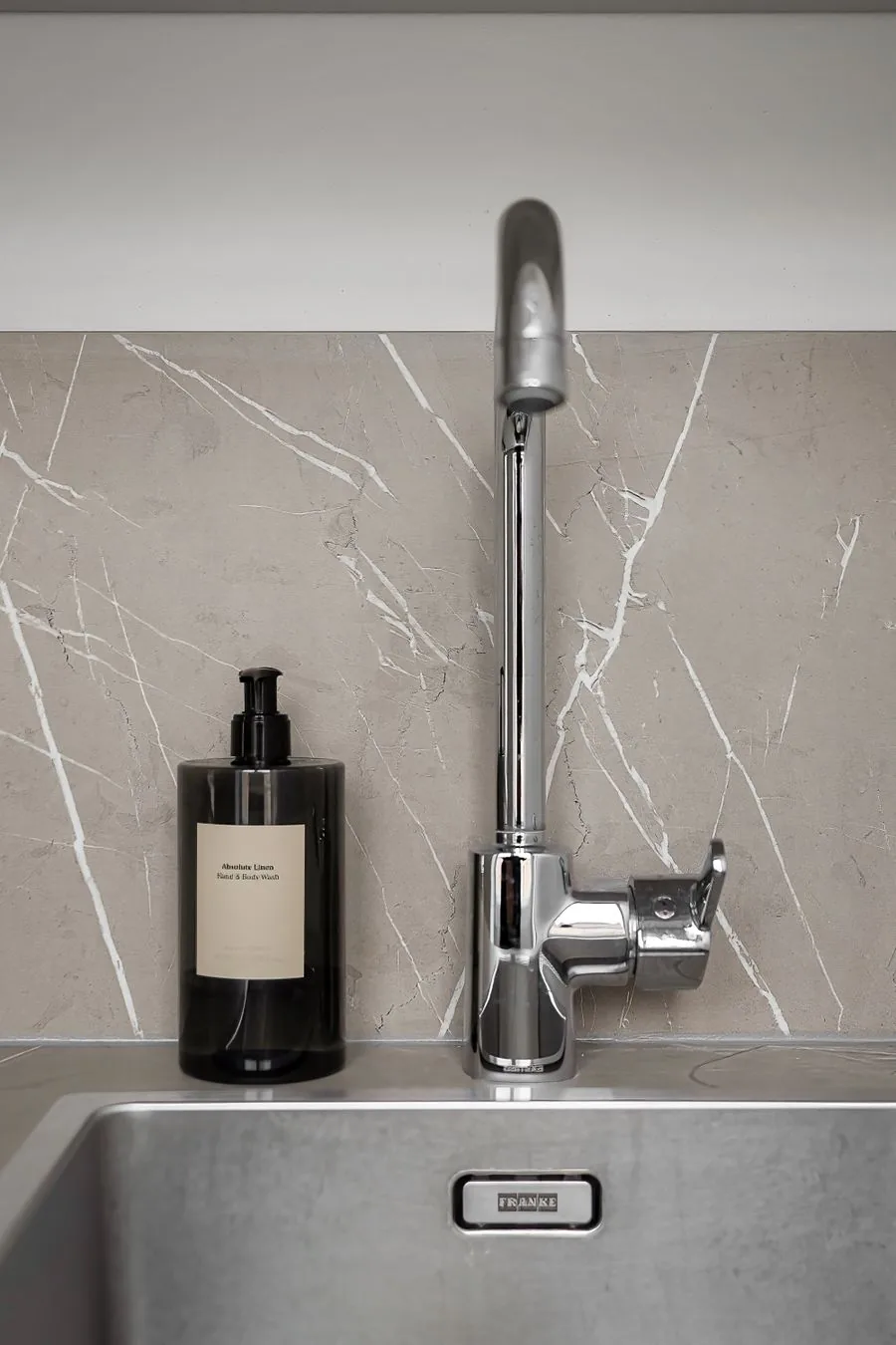 A clean modern kitchen faucet and sink