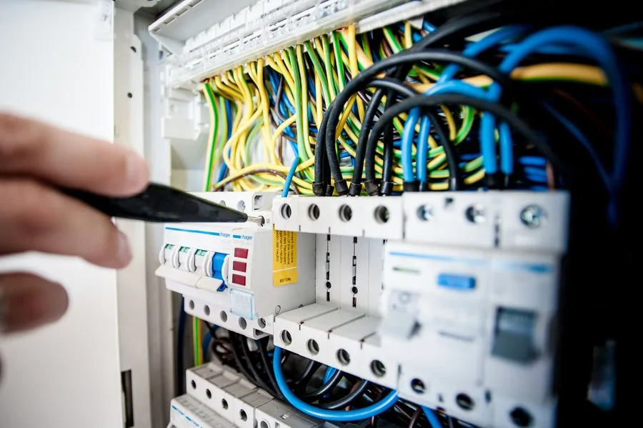 A vetted electrician working safely on home wiring