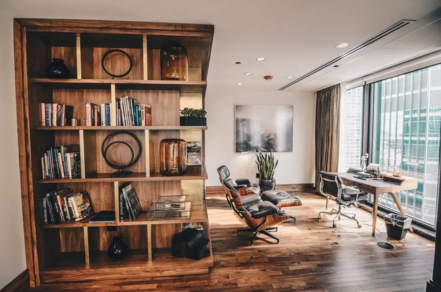 Wall-mounted wooden shelves styled with books in a bright room