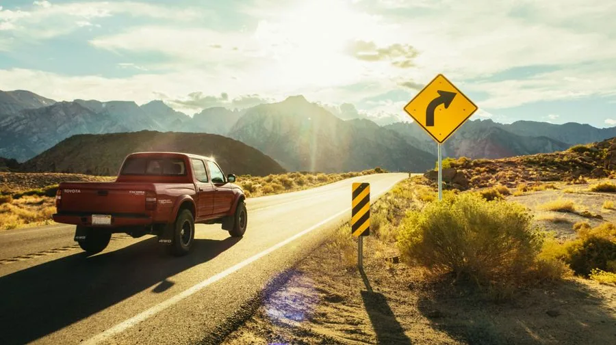 A pickup truck on the road, on its way to make a dump run