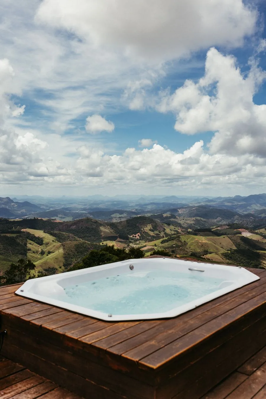 An outdoor hot tub on a wooden deck, the kind cut out and hauled away