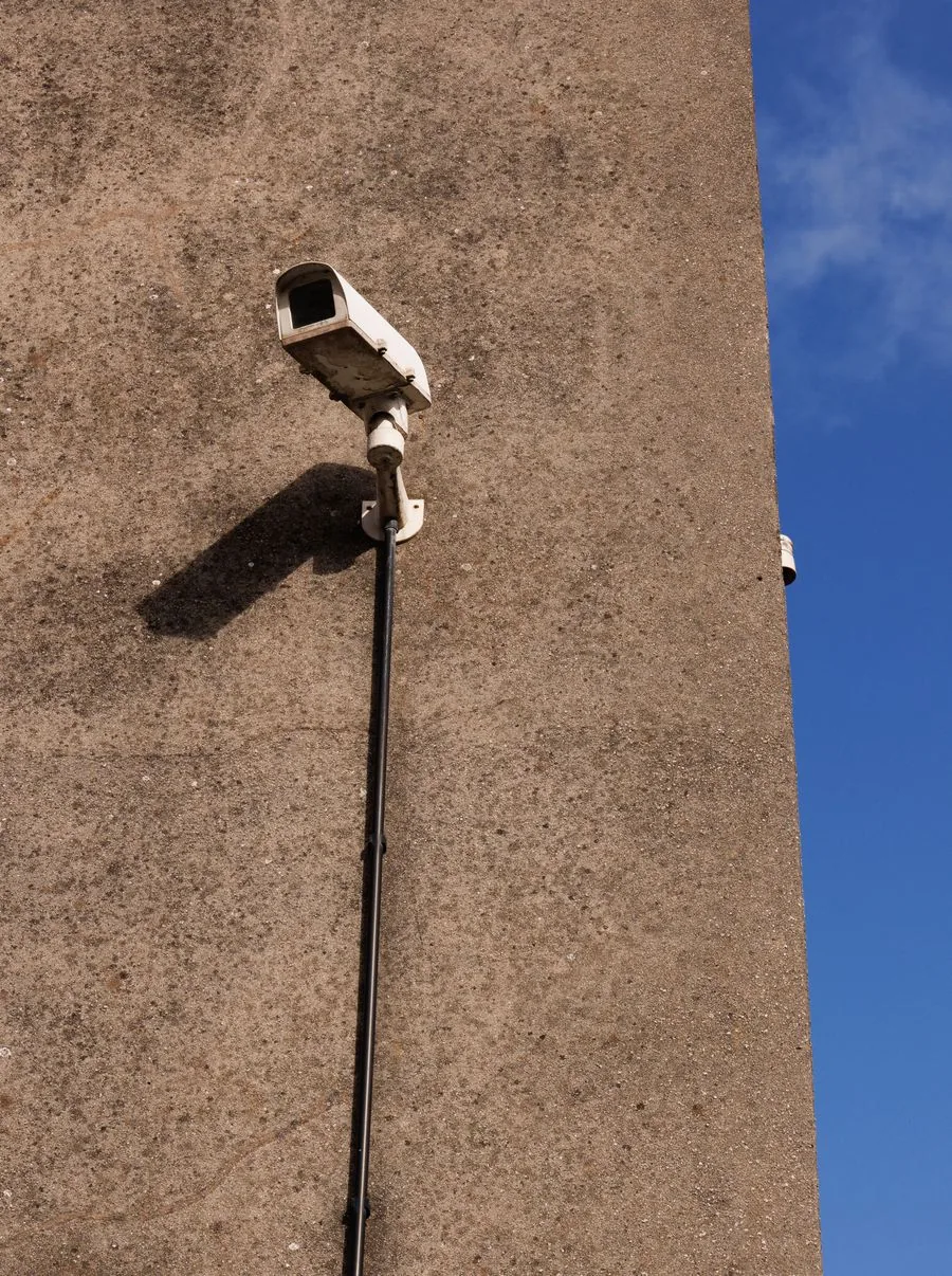 A home security camera mounted on an exterior wall