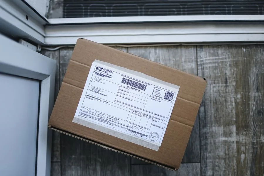 A labeled cardboard return box sitting by the front door, ready to go