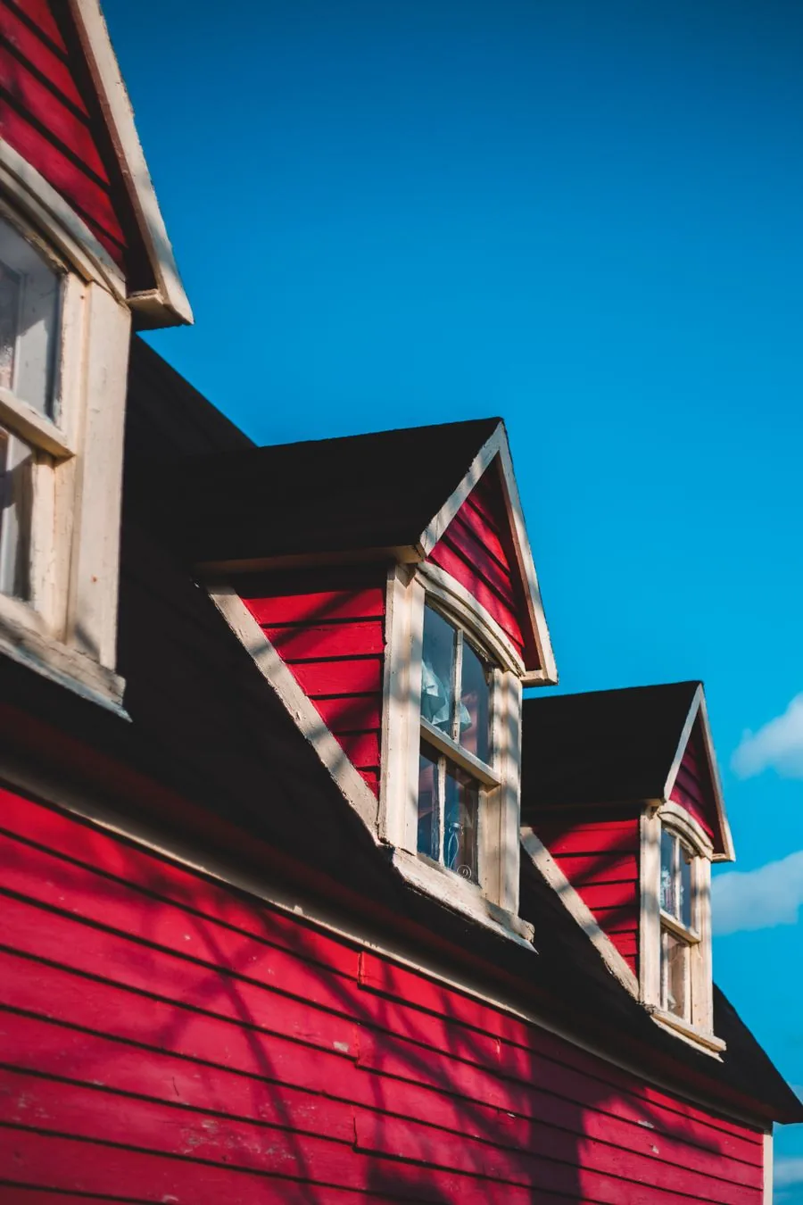 A bright residential roofline and eaves under a clear blue sky