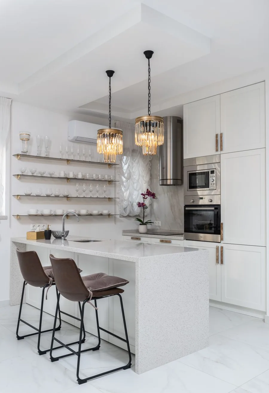 Modern pendant light fixtures hanging over a kitchen counter