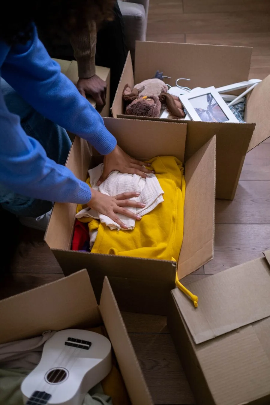 A packer wrapping and boxing belongings for a move