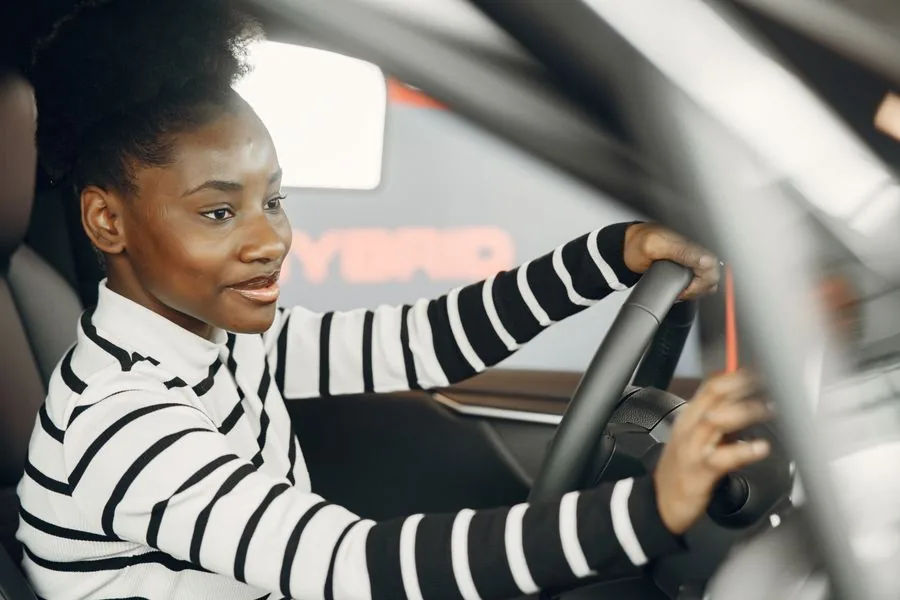 A friendly local driver smiling at the wheel