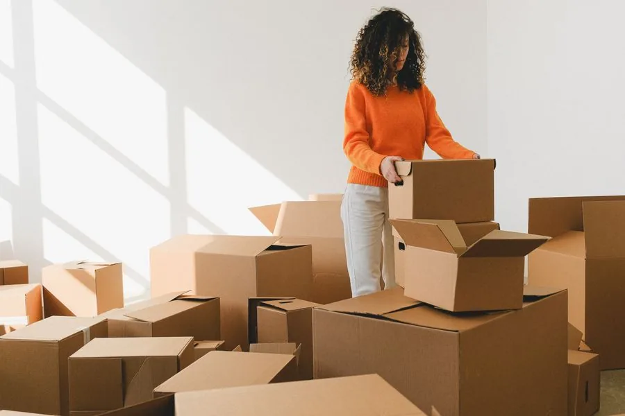 A young student packing boxes for a move into the dorm
