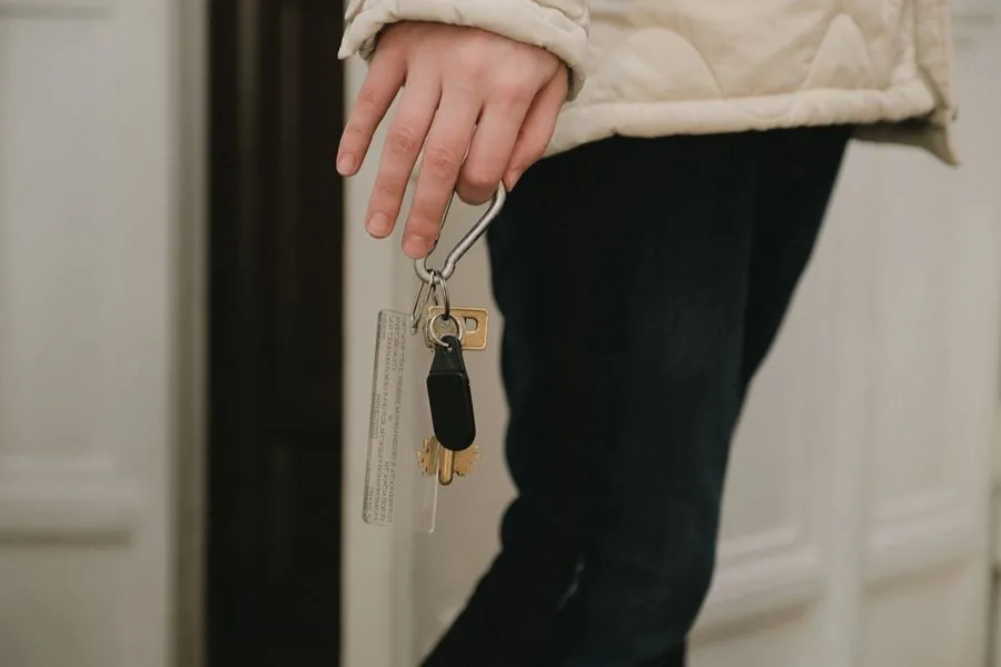 A trusted house sitter holding the keys to a home